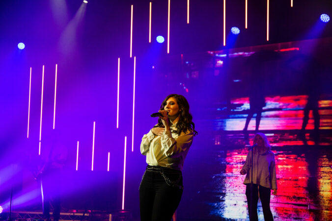 A photo of a woman singing on a stage